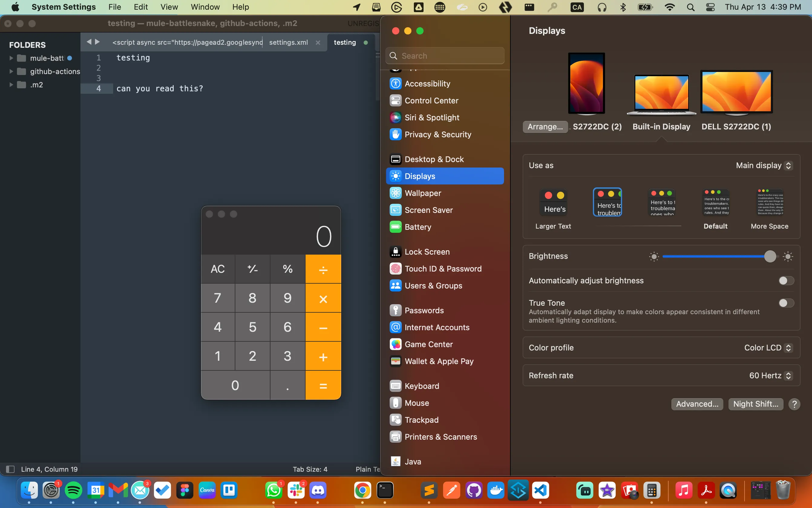 macOS desktop with a code editor and calculator app beside the System Settings Displays panel