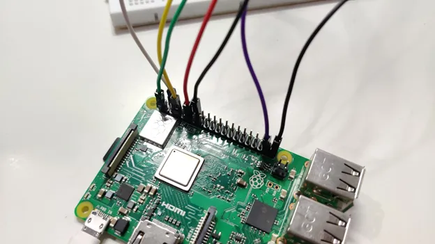 Raspberry Pi 3 with colored jumper wires connected to its GPIO header